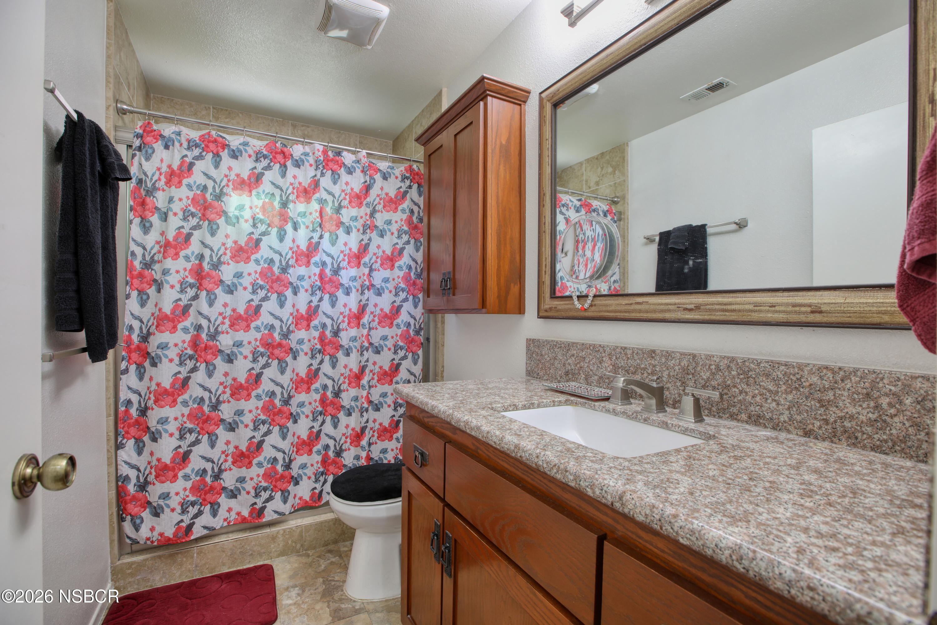 435-433 Eucalyptus Road, Unit 435433 Nipomo, CA 93444 - Photo 63 of 78 a bathroom with a granite countertop sink a mirror and shower curtain