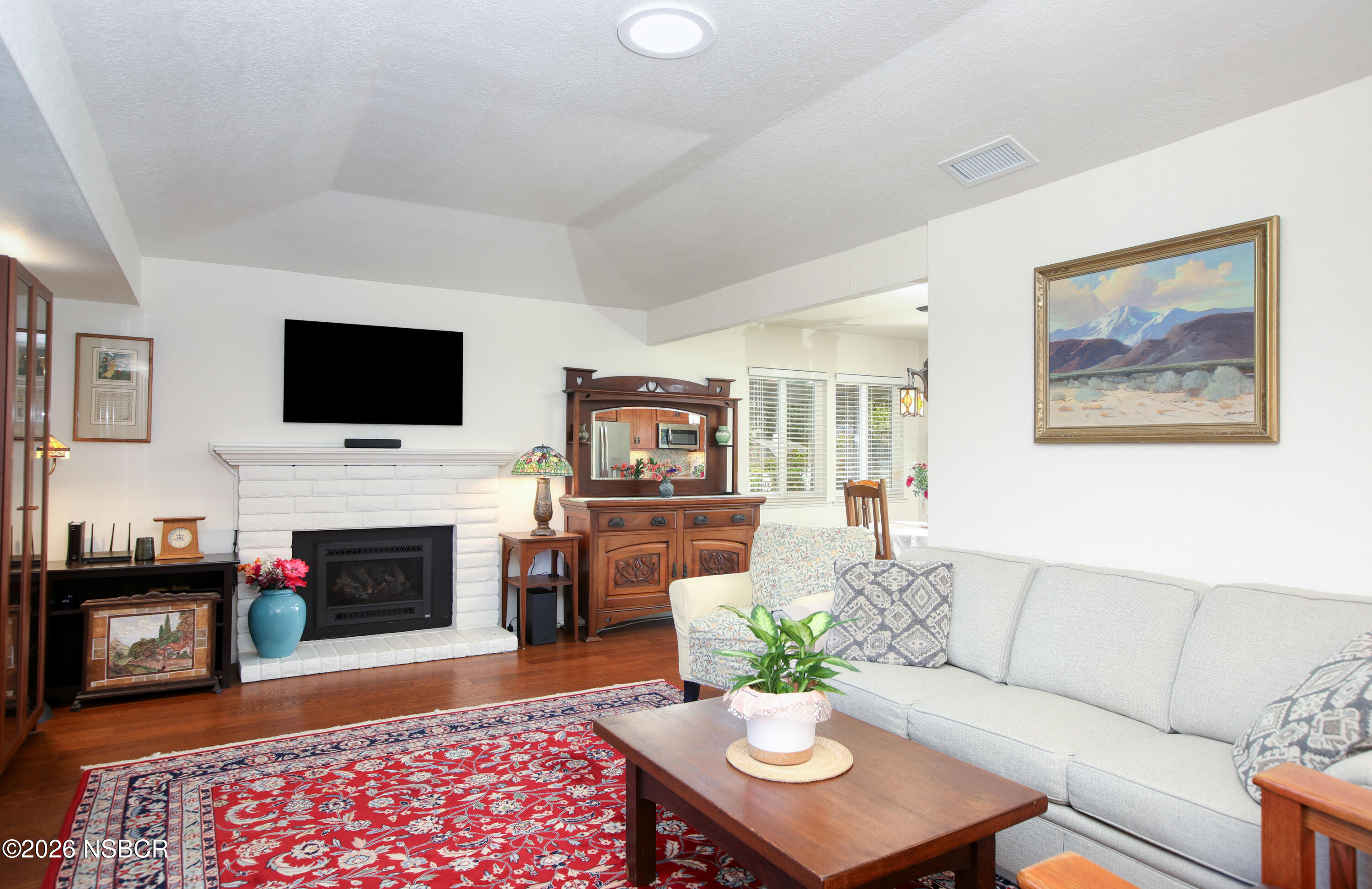 435-433 Eucalyptus Road, Unit 435433 Nipomo, CA 93444 - Photo 8 of 78 a living room with furniture a flat screen tv and a fireplace