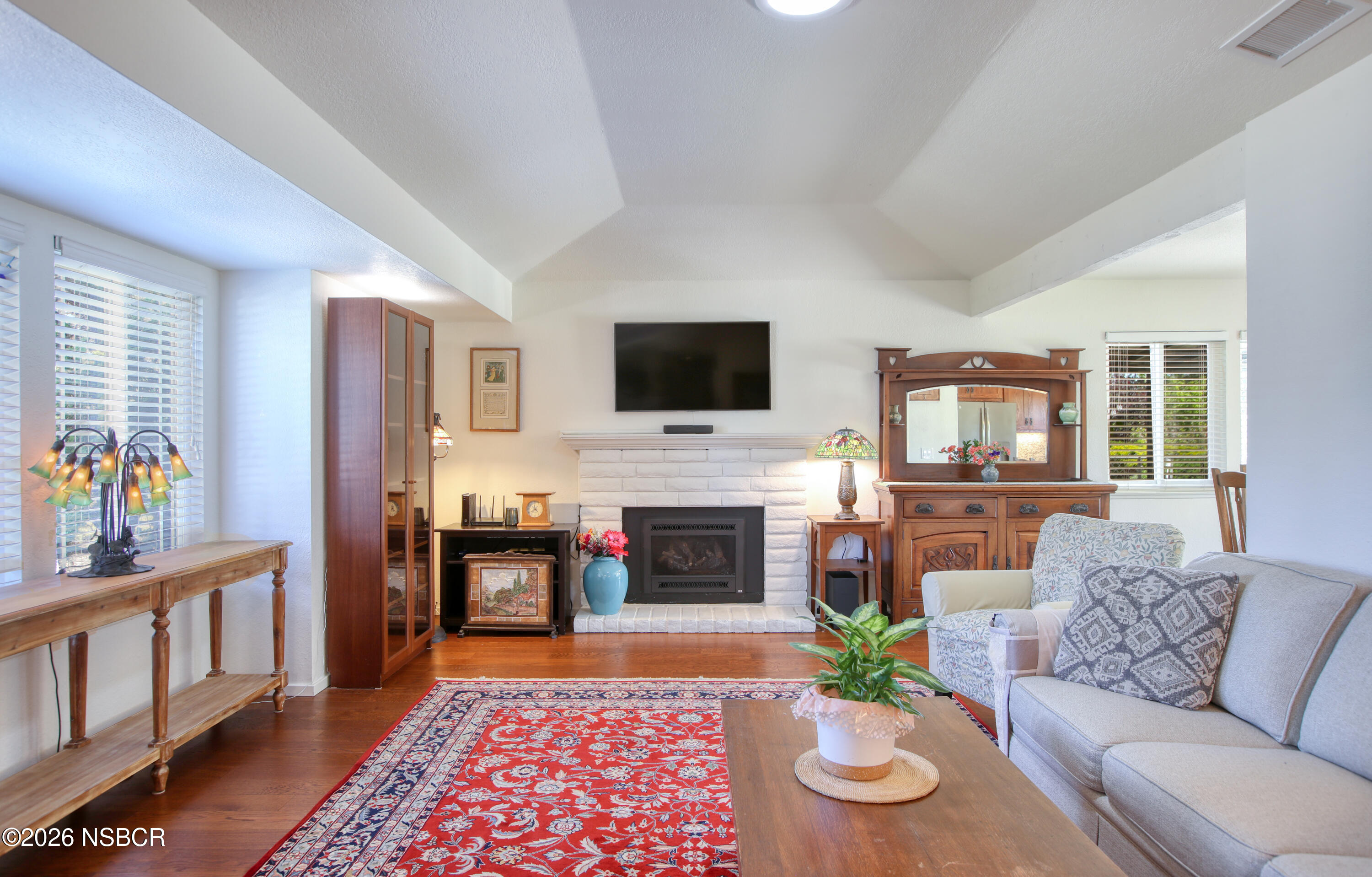435-433 Eucalyptus Road, Unit 435433 Nipomo, CA 93444 - Photo 10 of 78 a living room with furniture a fireplace and a flat screen tv