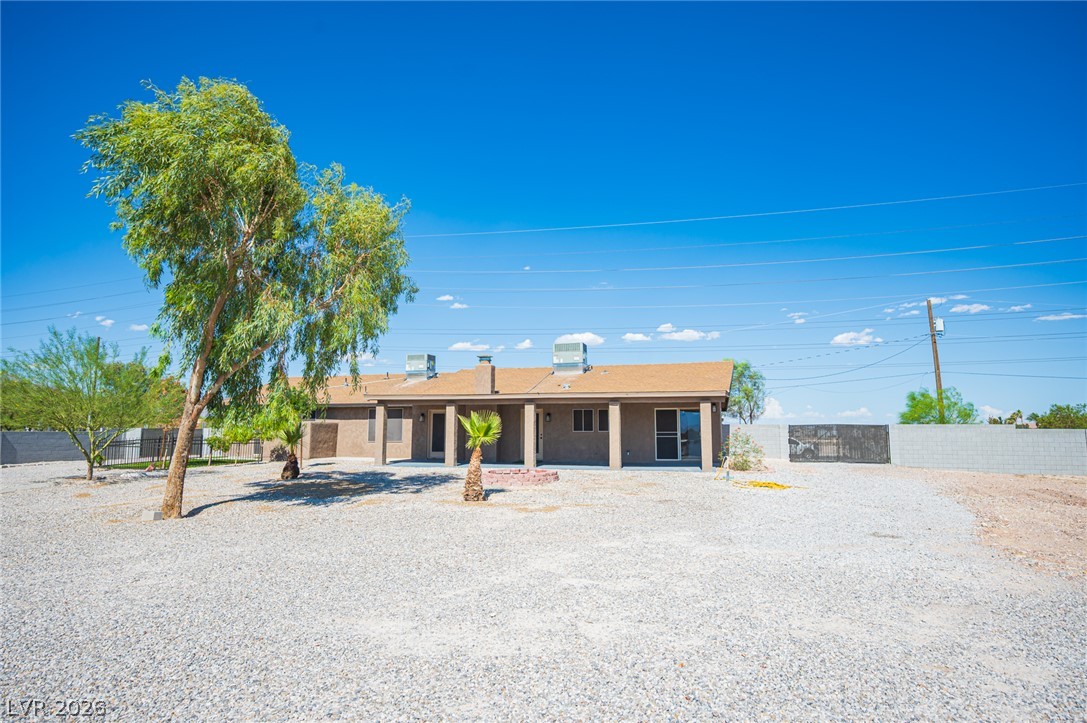 7041 North Decatur Boulevard Las Vegas, NV 89131 - Photo 32 of 33 A spacious backyard with a gravel landscape and covered patio offers ample outdoor living possibilities.
