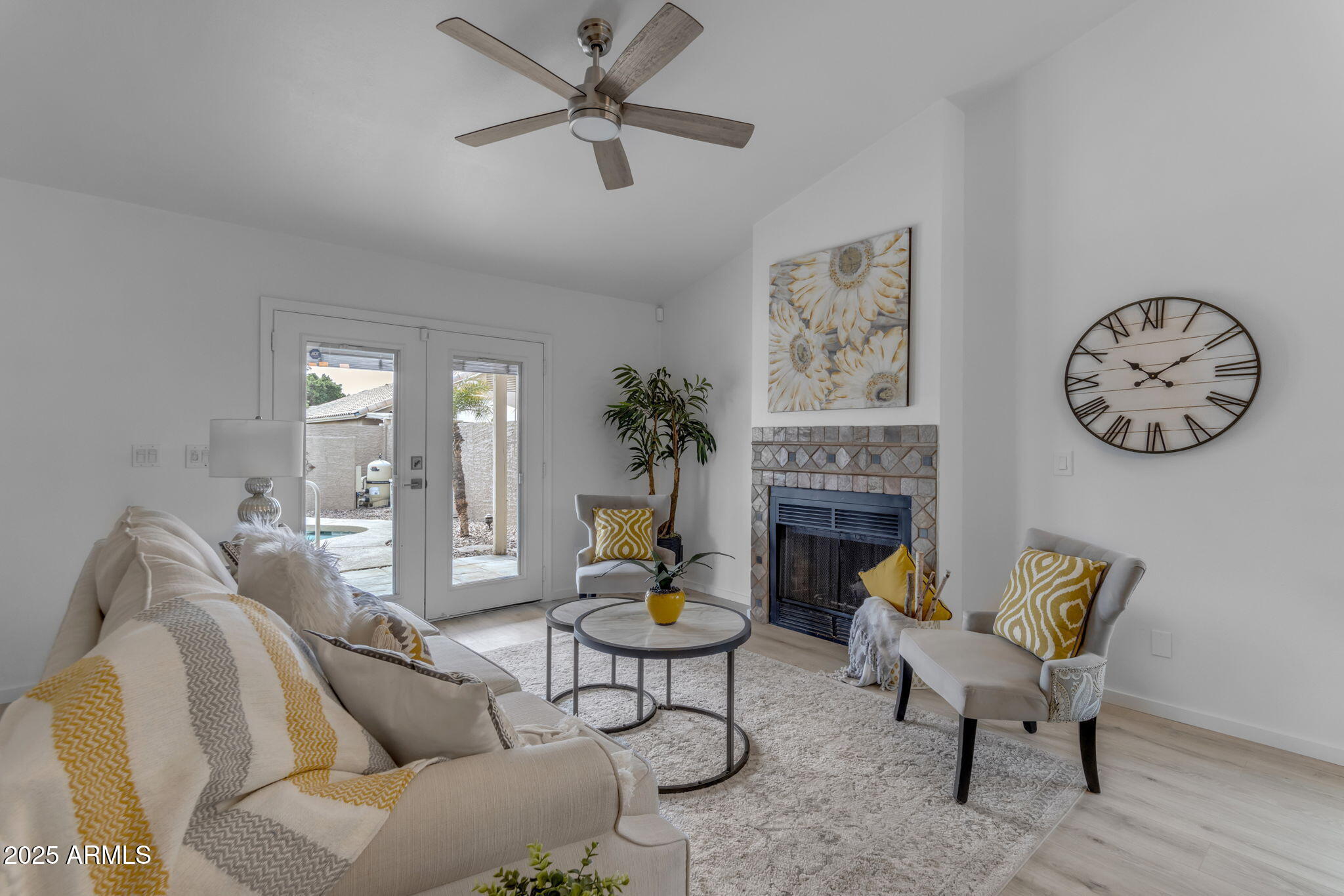 137 West Gary Way Gilbert, AZ 85233 - Photo 11 of 43 a living room with furniture a clock and a fireplace