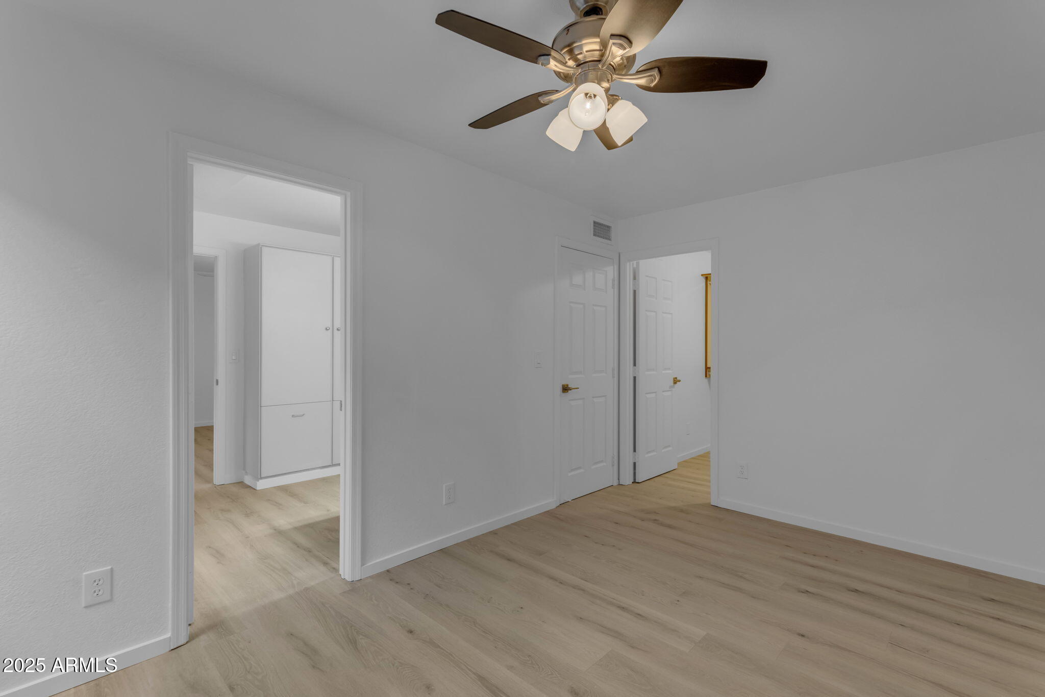 137 West Gary Way Gilbert, AZ 85233 - Photo 31 of 43 an empty room with a fan and a ceiling fan