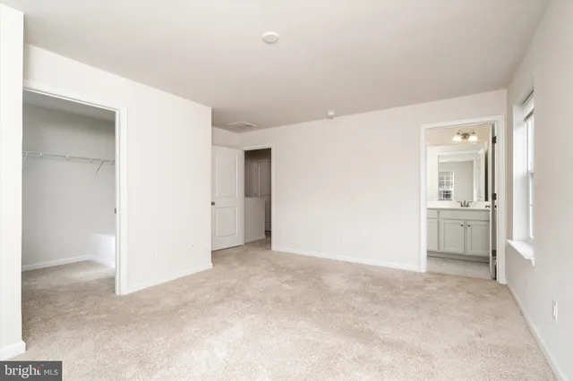 a view of a kitchen with a refrigerator and a sink
