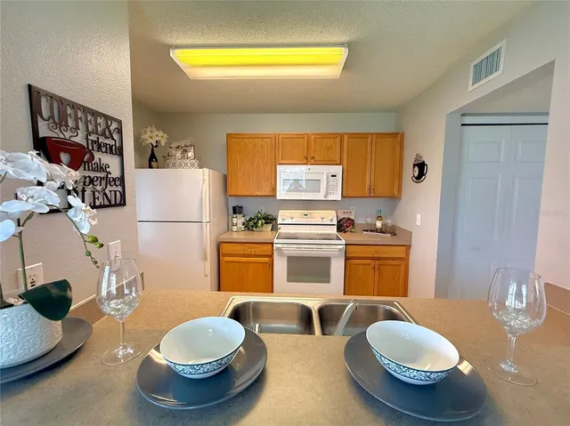 a kitchen with a sink and a refrigerator
