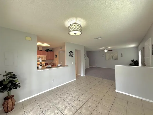 a view of a hallway to a livingroom with furniture