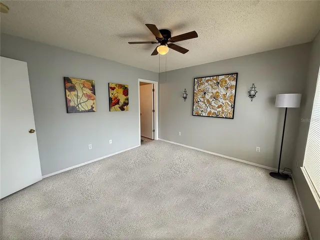 an empty room with windows and cabinet