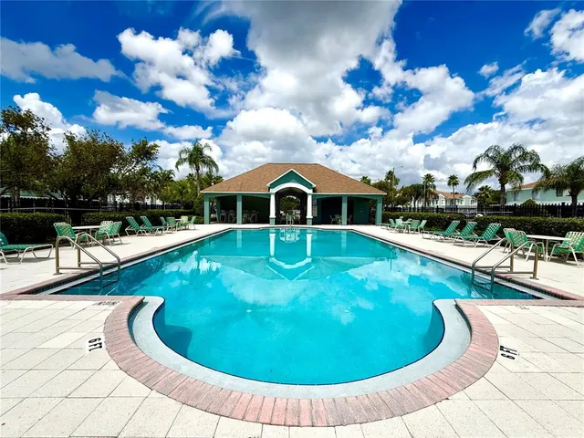 a view of a swimming pool with a yard