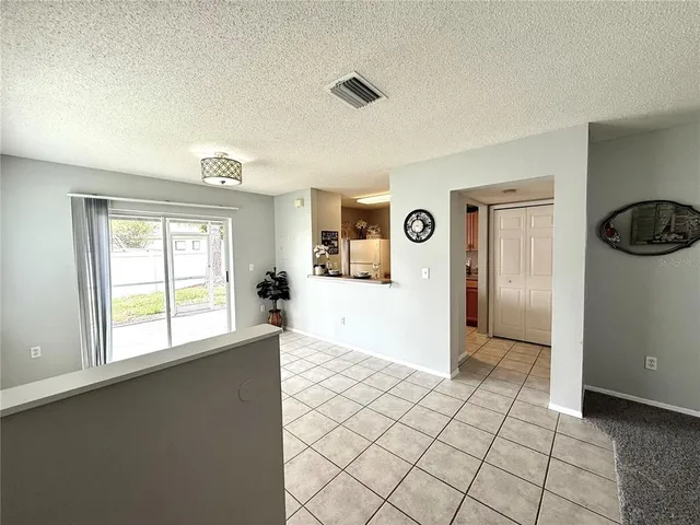 a view of a room with window and refrigerator
