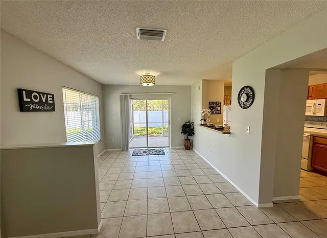 a view of an empty room with window and cabinet
