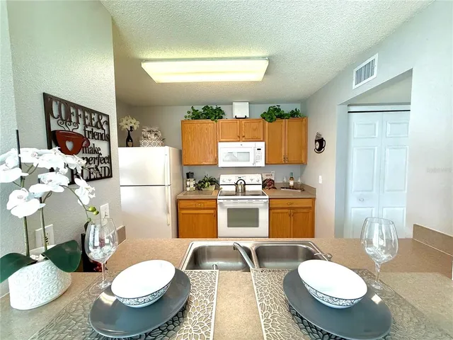 a kitchen with a sink and white appliances