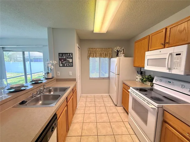 a kitchen with a sink stove and refrigerator
