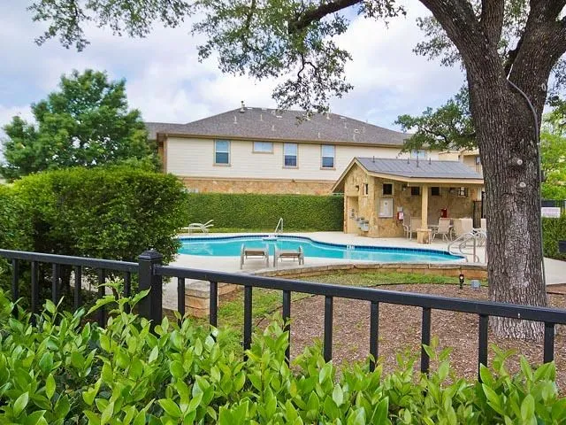 a view of a house with pool and sitting area