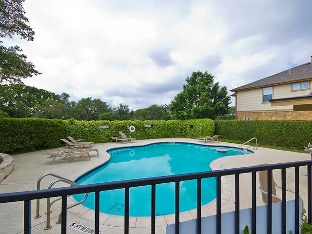 a view of a swimming pool and lounge chairs