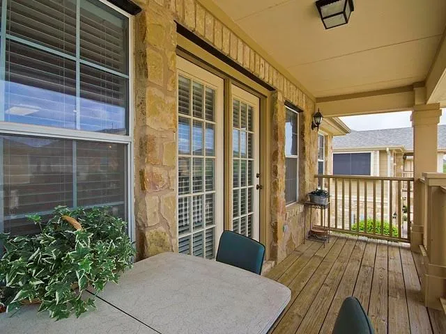 a view of balcony with wooden floor