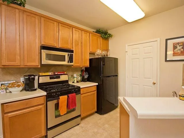 a kitchen with a refrigerator stove and microwave