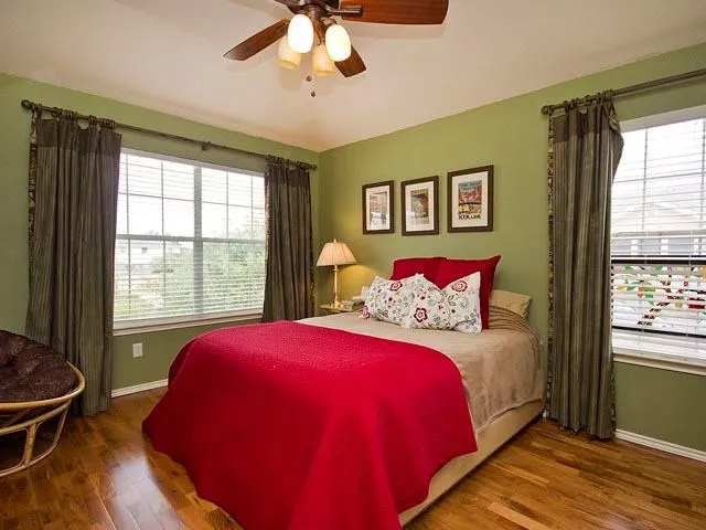 a bedroom with a bed and a window