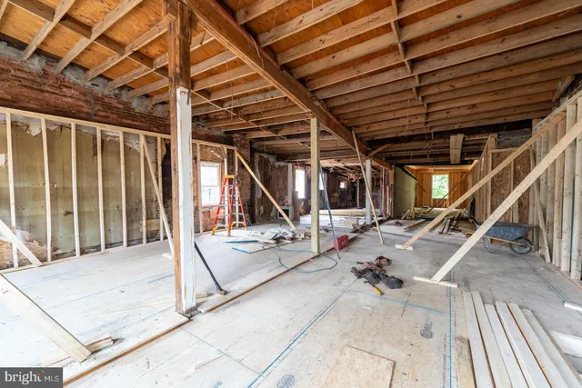 a view of a porch with a table and chairs