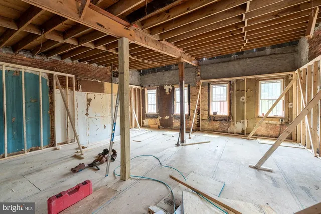a view of a livingroom with couch and wooden floor