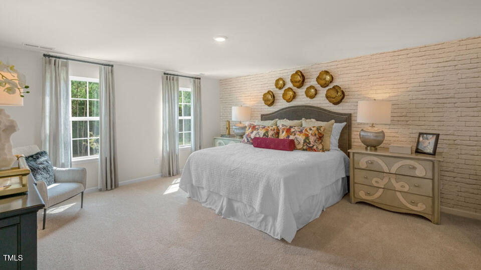 1209 Pavo Path Wendell, NC 27591 - Photo 13 of 28 a bedroom with a bed and a couch