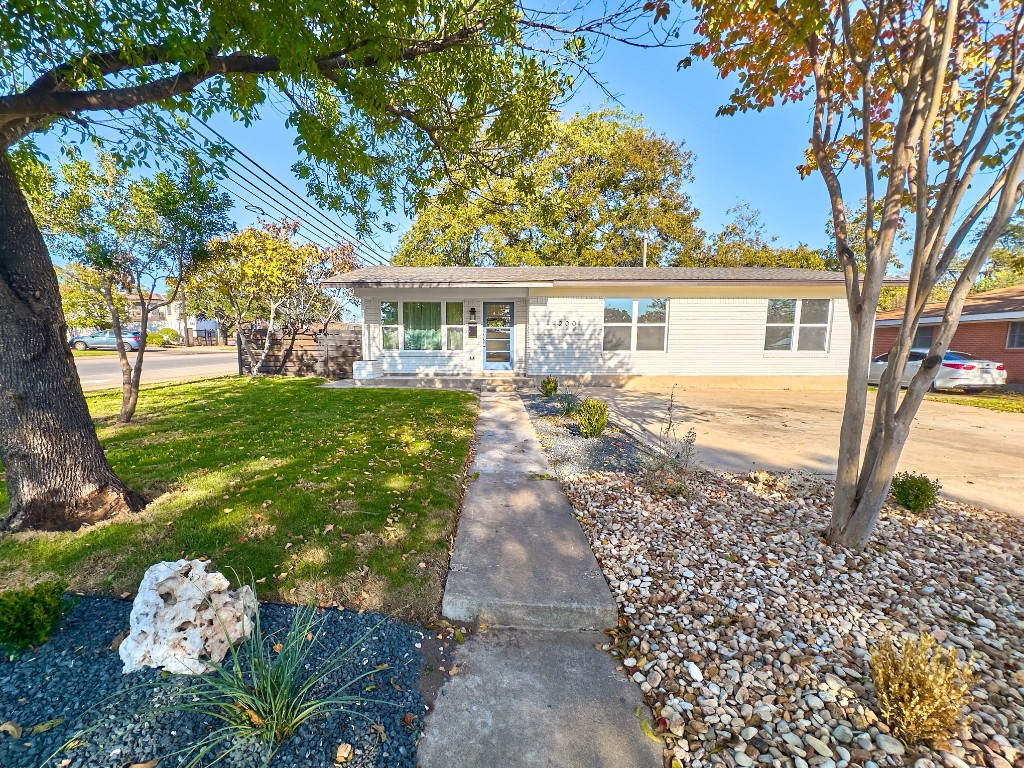 front view of a house with a yard