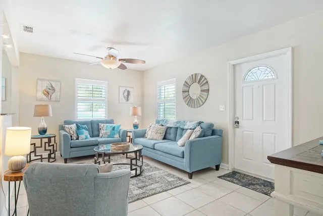a living room with furniture a clock and a window