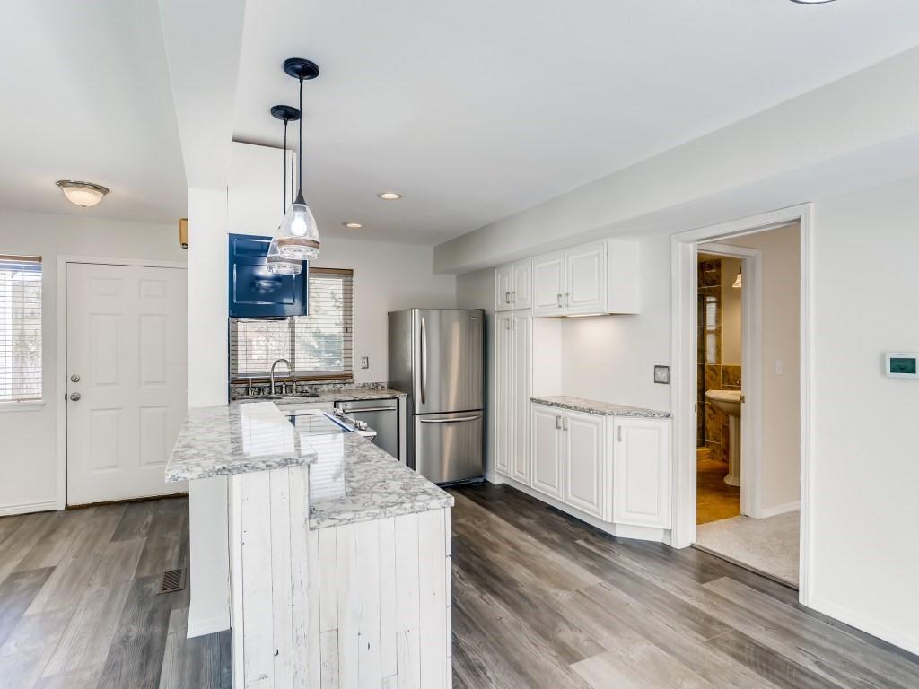 732 Alpine Road Dillon, CO 80435 - Photo 22 of 28 a kitchen with kitchen island a counter top space wooden floor and appliances