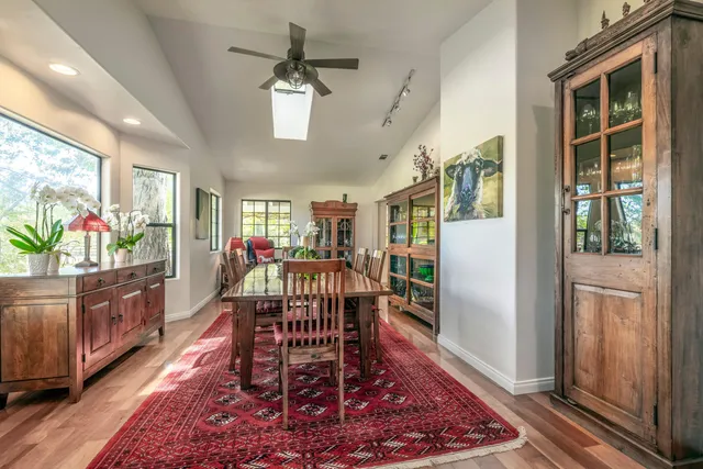 a view of a house with backyard and sitting area