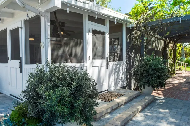 a bedroom with a bed a dresser next to a window