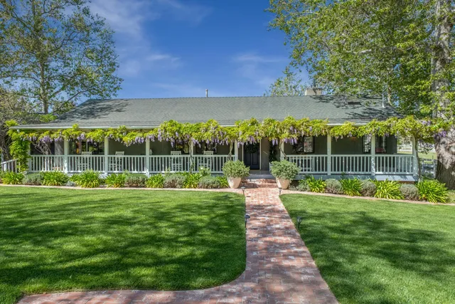 a view of a backyard with a garden and entertaining space