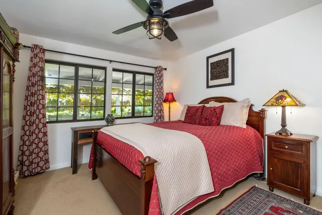 a bedroom with a large bed and a chandelier