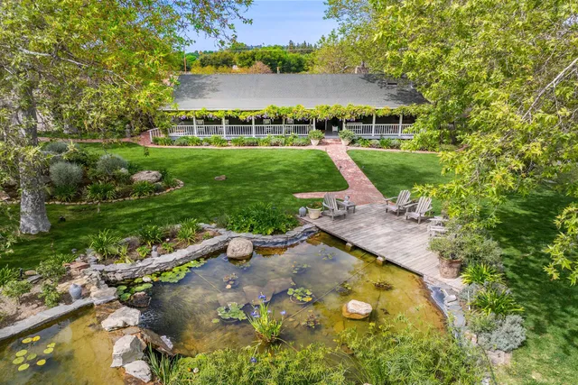 a view of a porch with a table and chairs