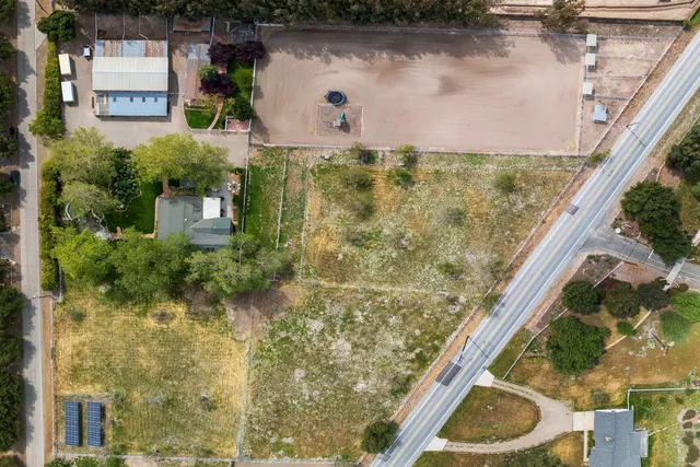 a view of a house with a window and wooden fence