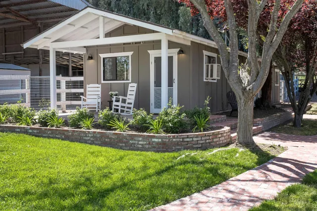 front view of a house with a tree