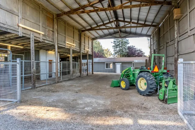 a backyard of a house with lots of green space and a fountain