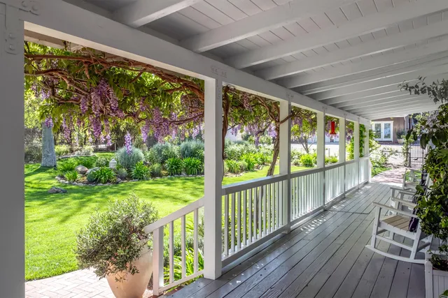 a living room with furniture a rug and a chandelier