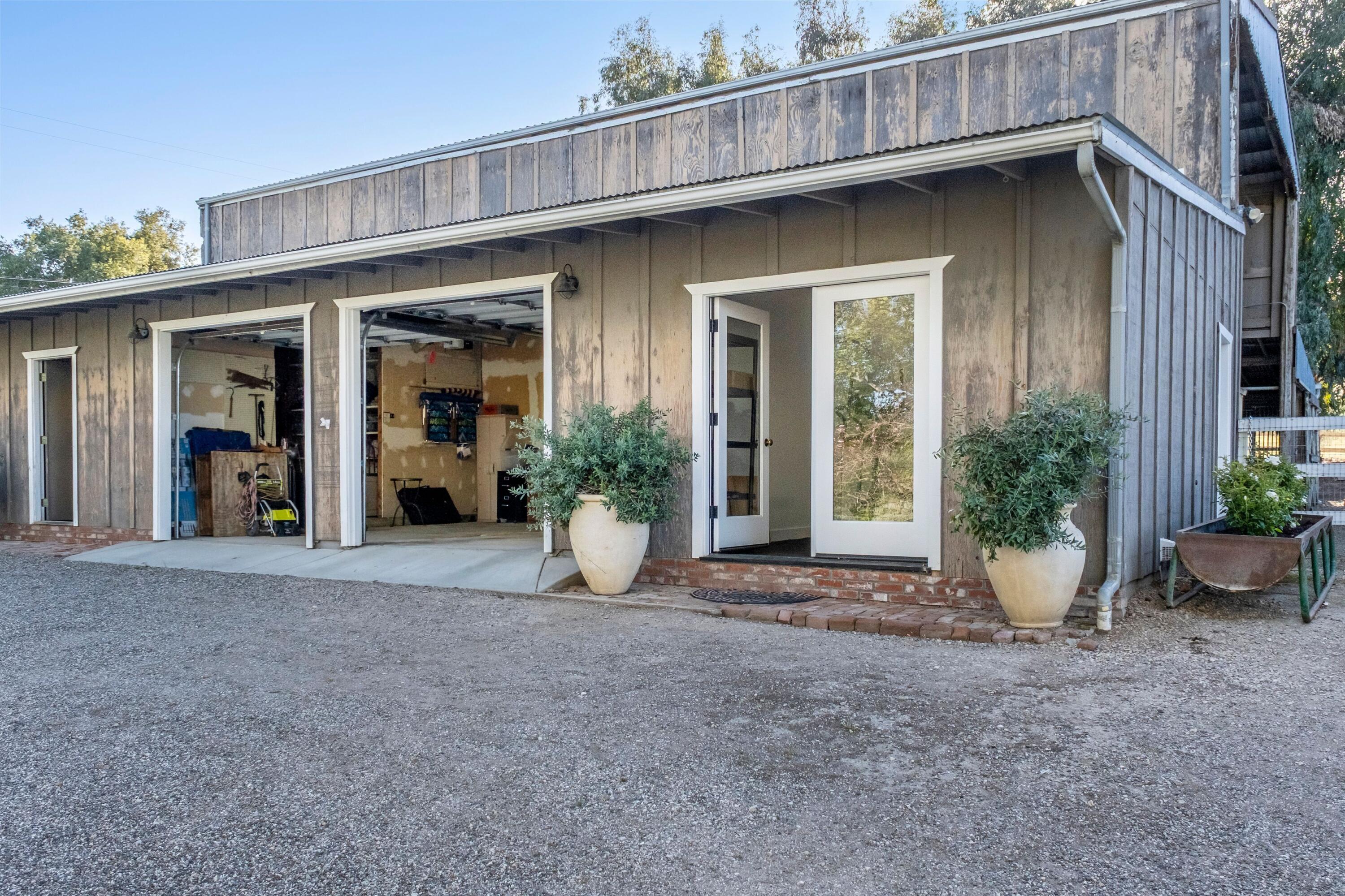 2921 Ontiveros Road Santa Ynez, CA 93460 - Photo 52 of 83 a view of a house with potted plants and a table