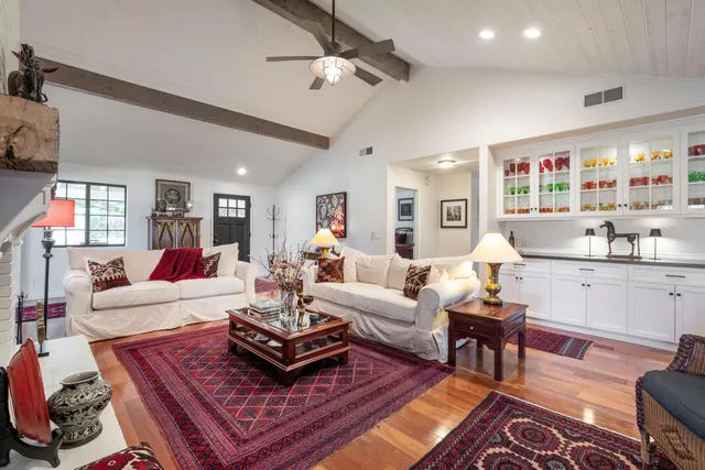 a kitchen with stainless steel appliances granite countertop a sink a refrigerator and a counter space