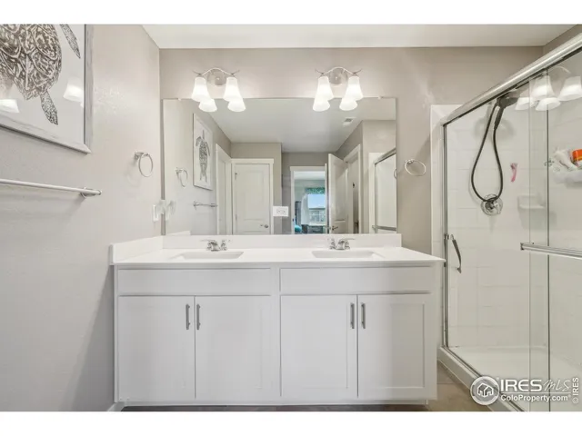 a bathroom with a double vanity sink and a mirror