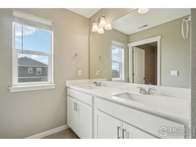a bathroom with a sink a vanity and a mirror