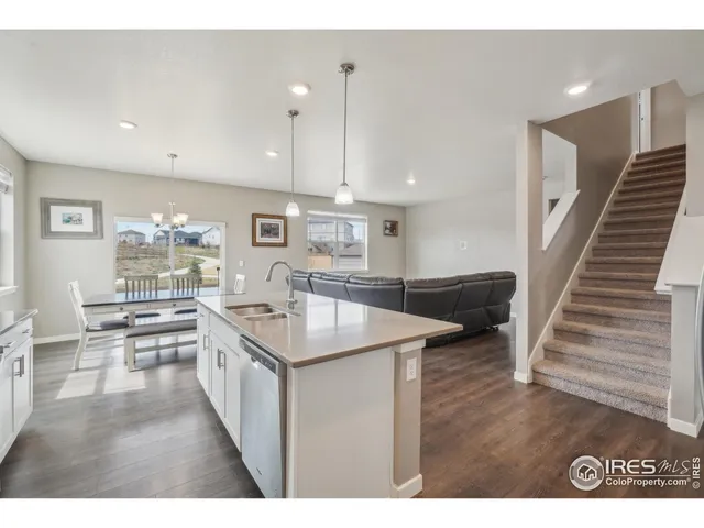 a kitchen with cabinets and wooden floors