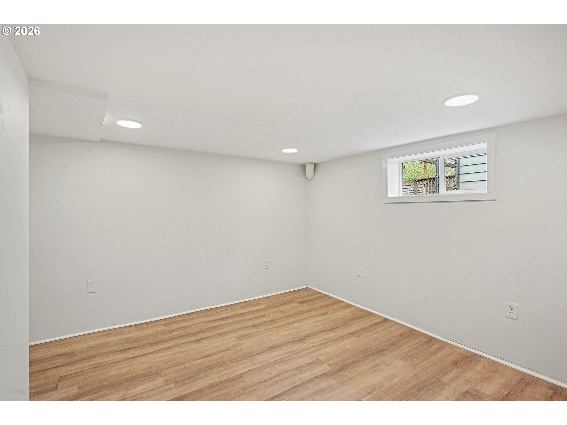 634 Northwest Ivy Street Camas, WA 98607 - Photo 17 of 27 a view of an empty room with wooden floor