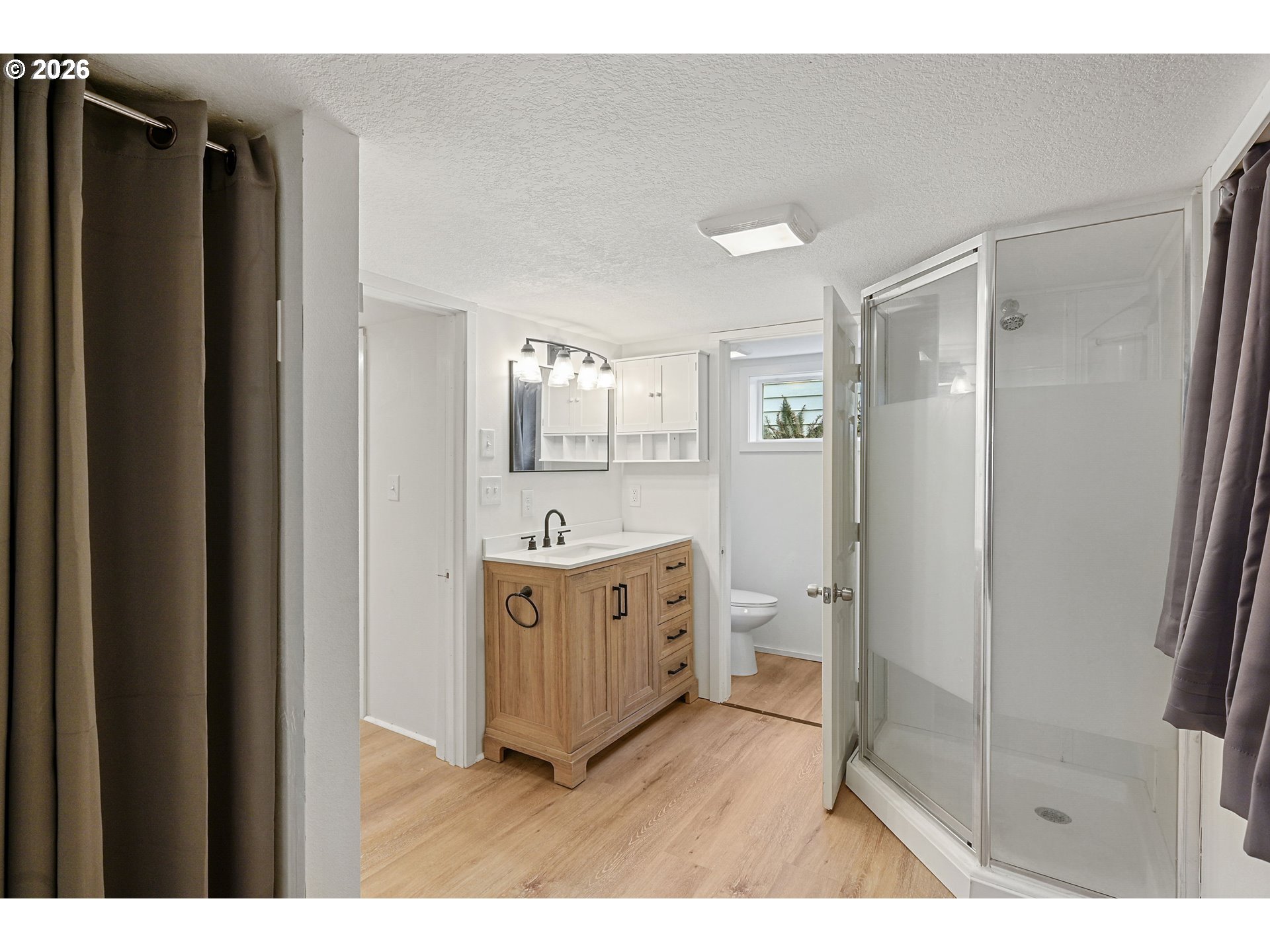 634 Northwest Ivy Street Camas, WA 98607 - Photo 19 of 27 a bathroom with a shower sink and mirror