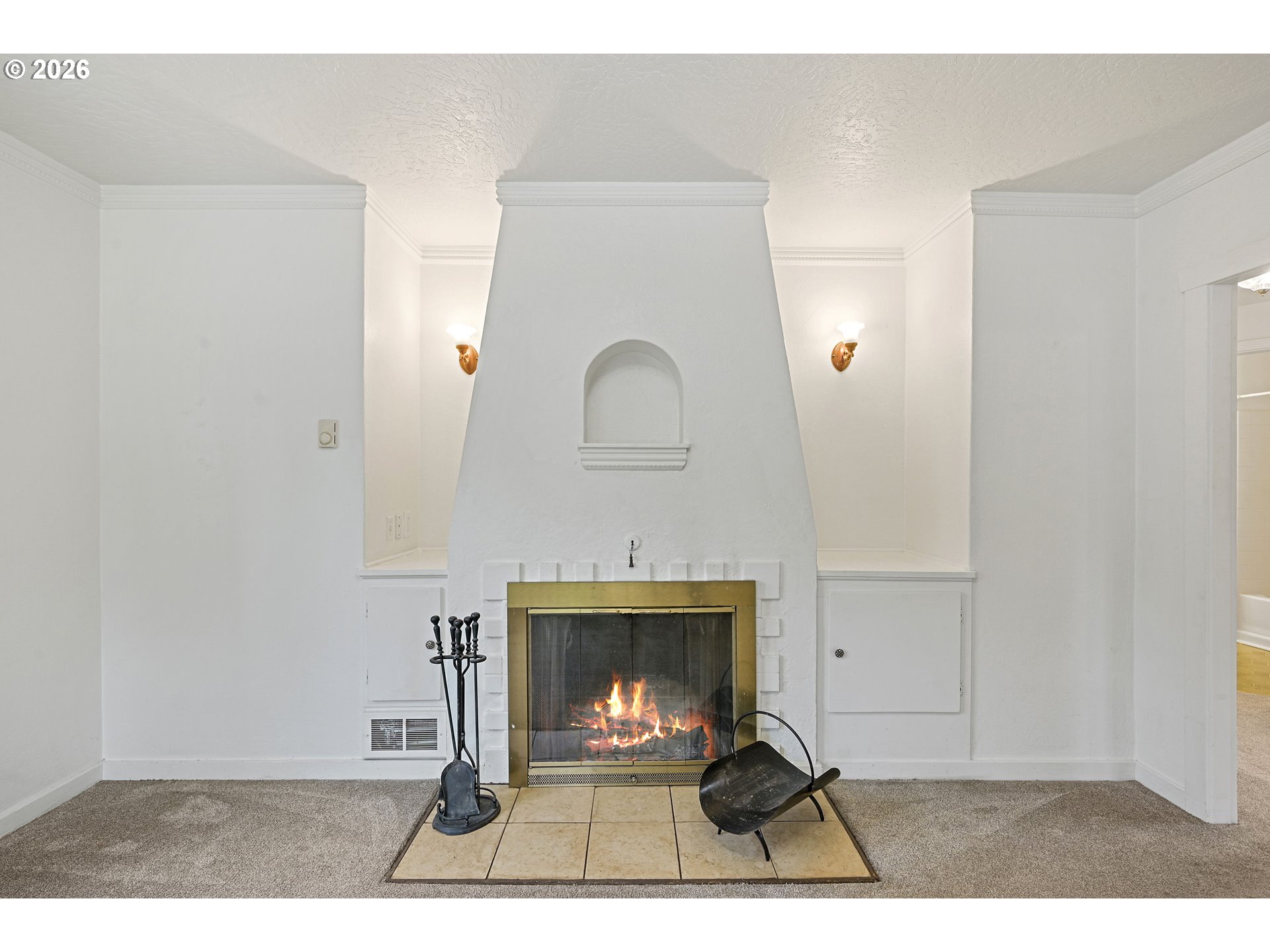 634 Northwest Ivy Street Camas, WA 98607 - Photo 4 of 27 a living room with fireplace furniture a rug and a wall painting
