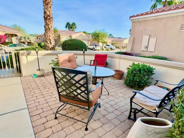 a view of a chairs and table in patio