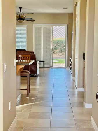 a hallway with a table and a window