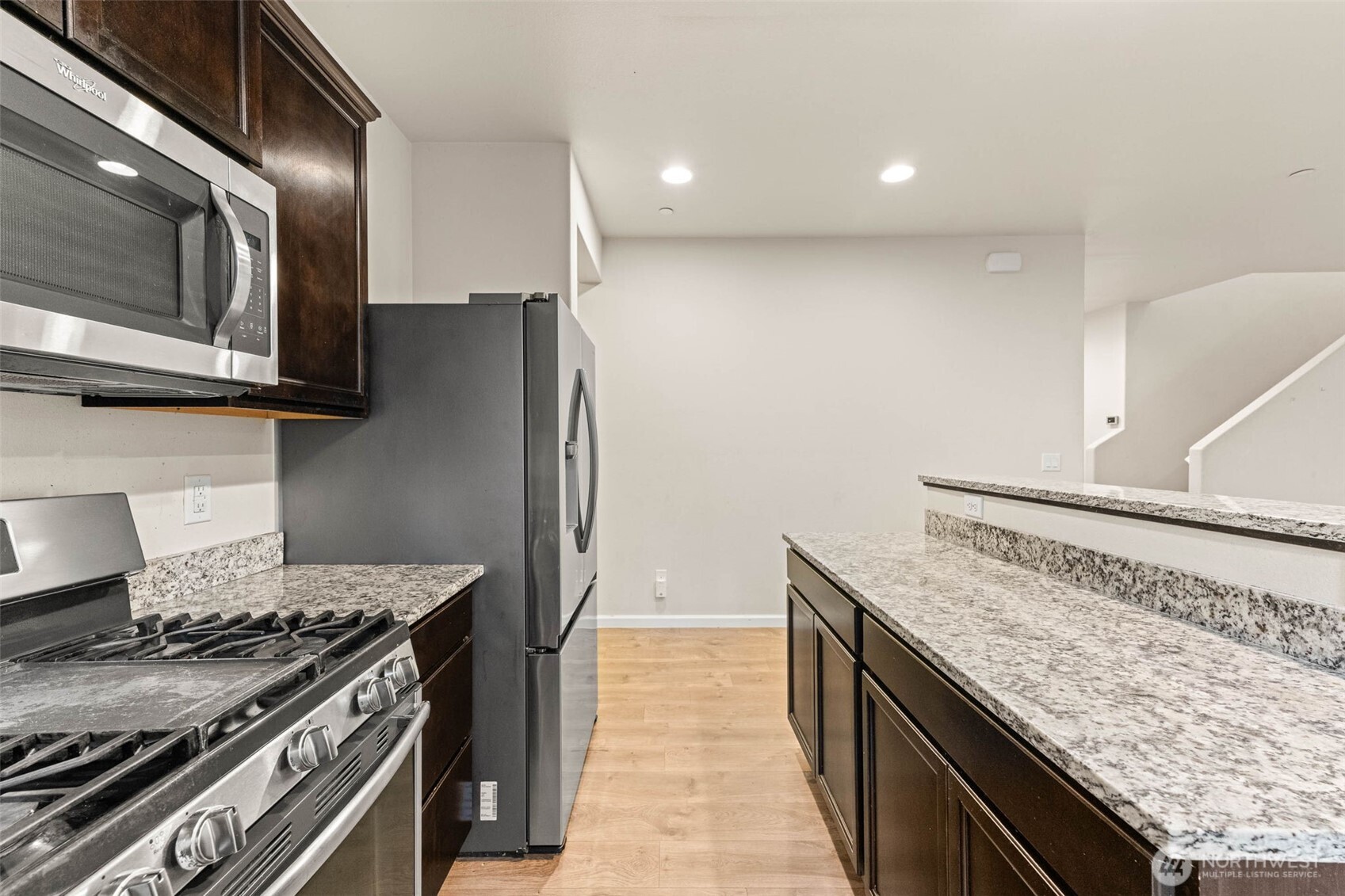 1705 Butler Court Northwest Olympia, WA 98502 - Photo 17 of 40 a kitchen with granite countertop a stove and a refrigerator