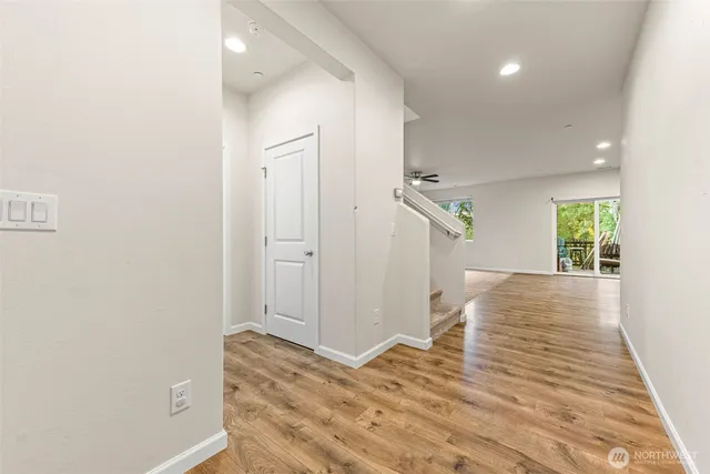 a view of hallway with wooden floor and front door
