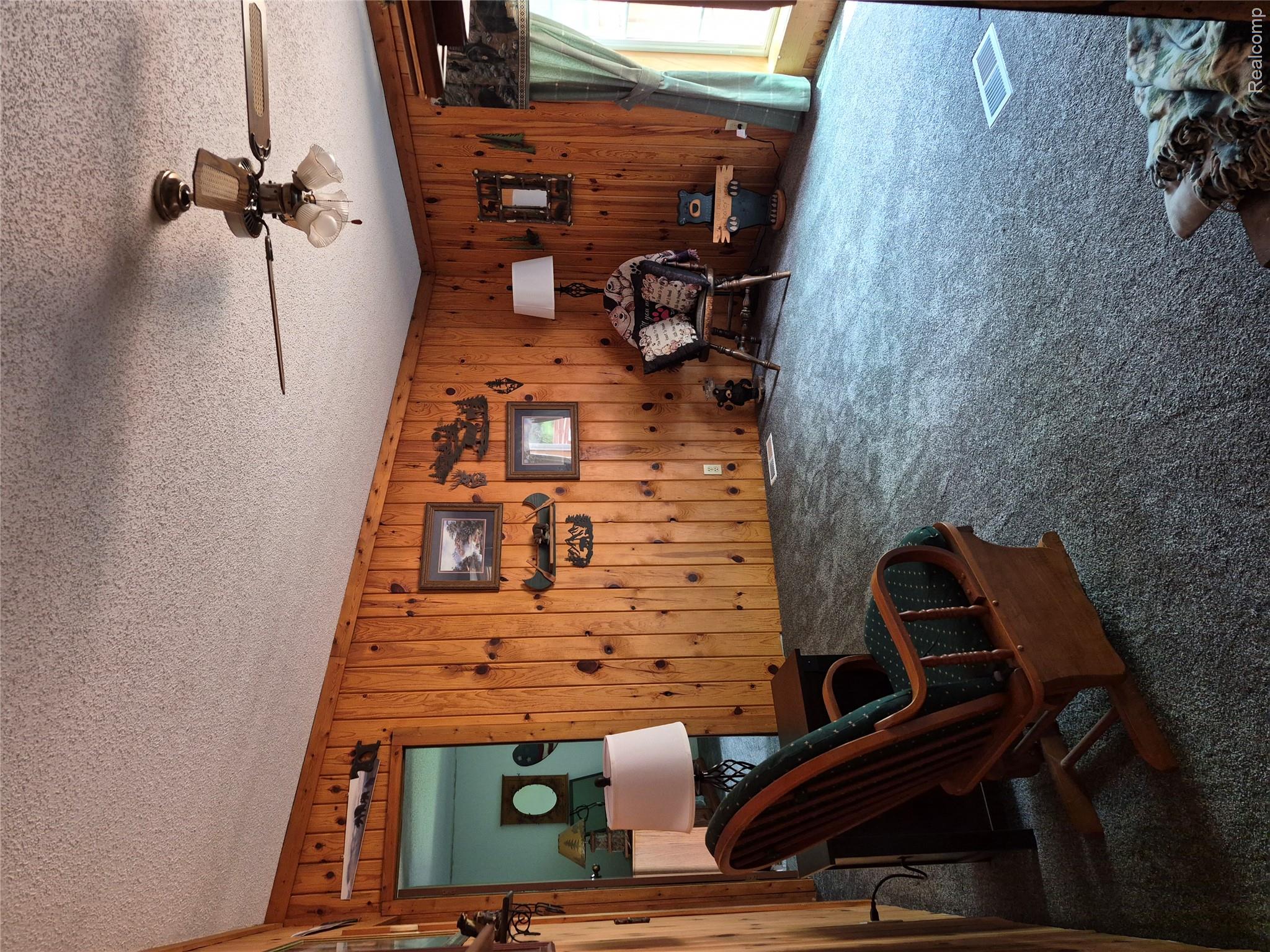 12849 South Delaney Road Perry, MI 48872 - Photo 12 of 34 Interior space featuring wood-paneled walls and a textured ceiling