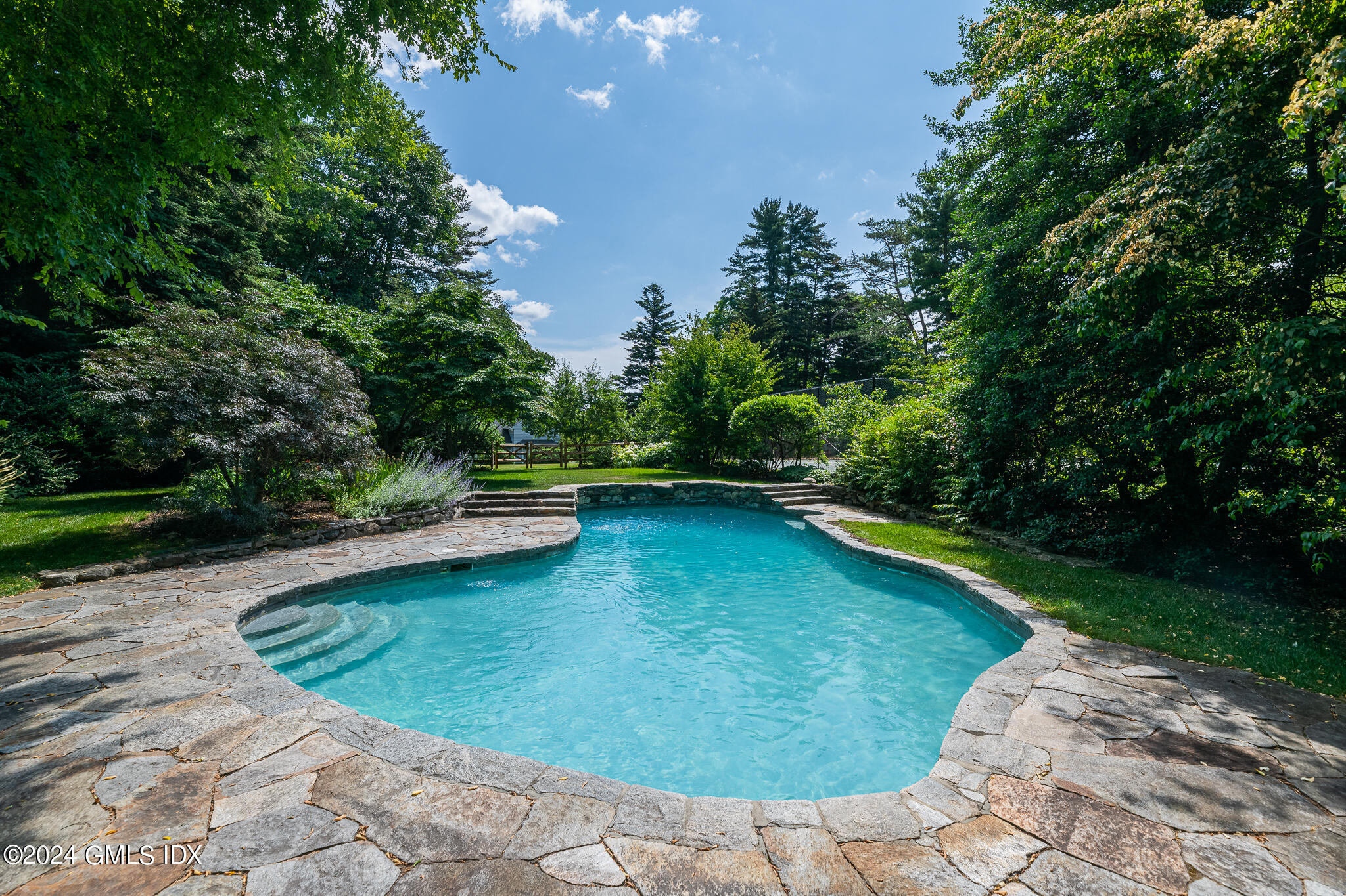 Undisclosed Address Greenwich, CT 06830 - Photo 2 of 19 a view of a backyard with swimming pool
