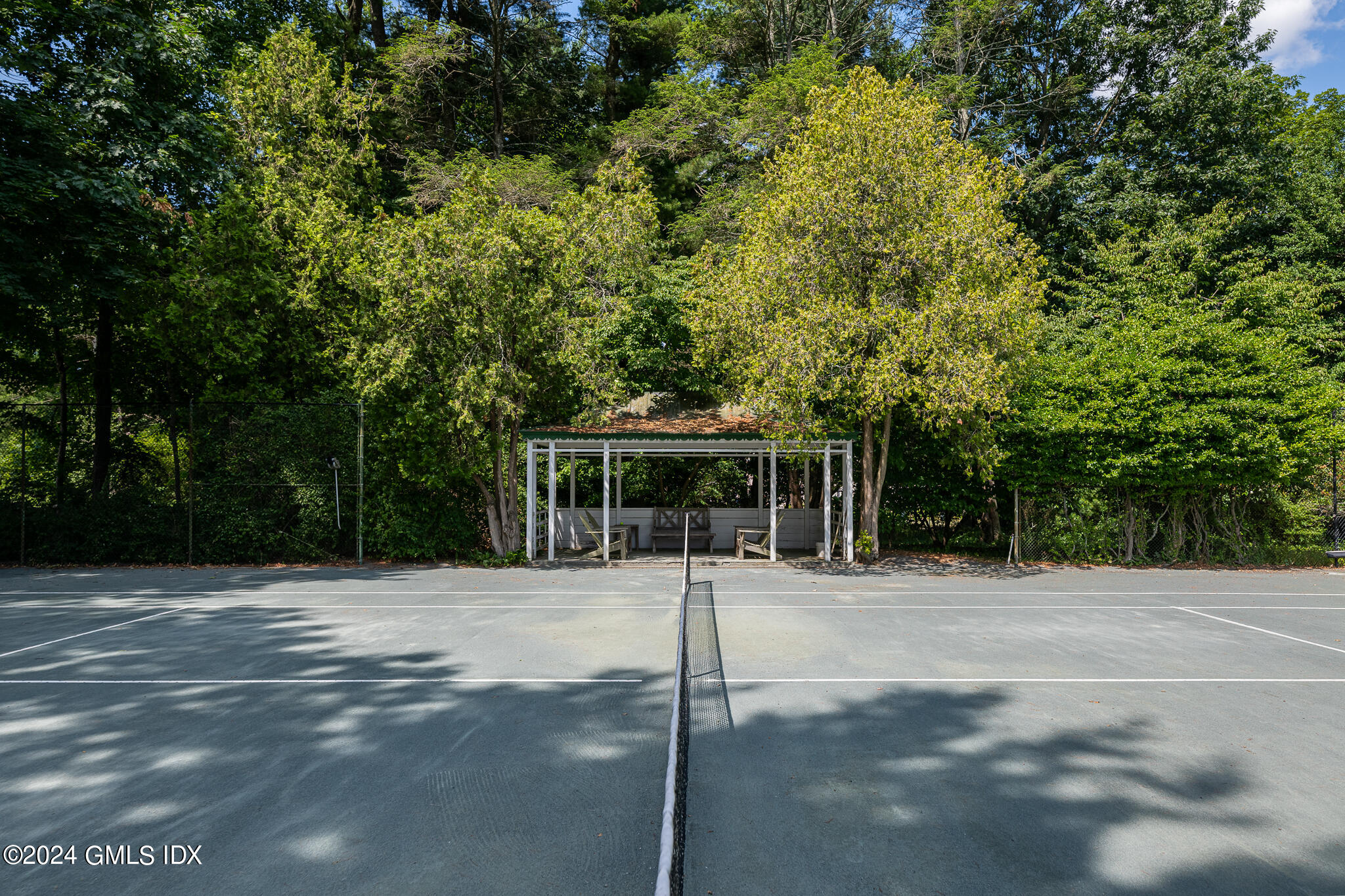 Undisclosed Address Greenwich, CT 06830 - Photo 3 of 19 a front view of a house with a tree